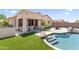 Serene backyard with pool, spa, patio, and lush turf, ideal for outdoor entertaining and relaxation at 16404 S 18Th Dr, Phoenix, AZ 85045