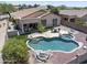A beautiful backyard featuring an outdoor kitchen, covered patio, green turf, and a custom pool and spa at 16404 S 18Th Dr, Phoenix, AZ 85045