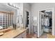 Bright bathroom with a vessel sink, walk-in closet, and a decorative mirror at 16404 S 18Th Dr, Phoenix, AZ 85045