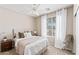 Cozy bedroom with a ceiling fan, a large window, a comfortable bed, and neutral tones at 16404 S 18Th Dr, Phoenix, AZ 85045