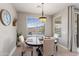 Cozy dining room featuring a round table, seating for four, and a window view at 16404 S 18Th Dr, Phoenix, AZ 85045