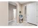 Welcoming foyer featuring a white front door, console table, and tiled flooring at 16404 S 18Th Dr, Phoenix, AZ 85045