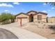 Exterior shot of a home with desert landscaping and a Real Estate sign at 16404 S 18Th Dr, Phoenix, AZ 85045