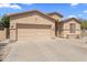 Exterior view of single-story home featuring a large garage and well-kept landscaping at 16404 S 18Th Dr, Phoenix, AZ 85045