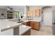 Modern kitchen with light wood cabinets, white countertops and stainless steel appliances at 16404 S 18Th Dr, Phoenix, AZ 85045