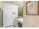 Well-lit laundry room with modern appliances, built-in cabinets, and neutral walls at 16404 S 18Th Dr, Phoenix, AZ 85045