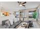 Open-concept living room flows into the kitchen, featuring a large sectional sofa and natural light at 16404 S 18Th Dr, Phoenix, AZ 85045