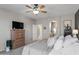 Spacious main bedroom featuring a ceiling fan, a dresser, carpeting, and an en-suite bathroom at 16404 S 18Th Dr, Phoenix, AZ 85045