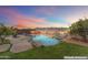 Beautiful rock-lined pool and spa with mountain views for relaxation and outdoor enjoyment at twilight at 16404 S 18Th Dr, Phoenix, AZ 85045