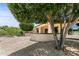 Lush backyard featuring mature landscaping, a patio, and gravel ground cover at 16716 W Rincon Peak Dr, Surprise, AZ 85387