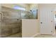 Modern bathroom featuring a glass enclosed shower with stylish tile and updated fixtures at 16716 W Rincon Peak Dr, Surprise, AZ 85387