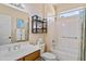 Well-lit bathroom featuring a bath and shower combo and stylish shelving unit at 16716 W Rincon Peak Dr, Surprise, AZ 85387