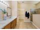 Modern bathroom with double vanity, large mirrors, and a walk-in shower at 16716 W Rincon Peak Dr, Surprise, AZ 85387