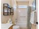 Bright and airy bathroom with a shower and bath combo with neutral color and modern fixtures at 16716 W Rincon Peak Dr, Surprise, AZ 85387