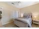 Comfortable bedroom featuring a ceiling fan and a double door closet at 16716 W Rincon Peak Dr, Surprise, AZ 85387