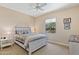 Cozy bedroom with a ceiling fan and a large window letting in natural light at 16716 W Rincon Peak Dr, Surprise, AZ 85387