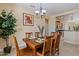Inviting dining room with wood table and chandelier, open to the kitchen at 16716 W Rincon Peak Dr, Surprise, AZ 85387