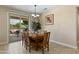 Elegant dining area featuring a wooden table, chandelier, and sliding doors leading to the patio at 16716 W Rincon Peak Dr, Surprise, AZ 85387