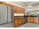 Bright and airy kitchen featuring wooden cabinets, stainless steel appliances, and granite countertops at 16716 W Rincon Peak Dr, Surprise, AZ 85387