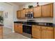Well-equipped kitchen featuring stainless steel appliances, granite countertops, and light wood cabinetry at 16716 W Rincon Peak Dr, Surprise, AZ 85387