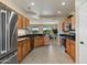 Bright and airy kitchen featuring wooden cabinets, stainless steel appliances, and granite countertops at 16716 W Rincon Peak Dr, Surprise, AZ 85387