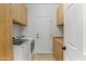 Bright laundry room with cabinets, countertops, and modern washer and dryer for convenient chores at 16716 W Rincon Peak Dr, Surprise, AZ 85387