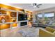 Stylish living room with built-in shelves, a fireplace, and large windows offering outdoor views at 16716 W Rincon Peak Dr, Surprise, AZ 85387