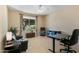 Versatile room perfect for a home office with a large window and neutral decor at 16716 W Rincon Peak Dr, Surprise, AZ 85387