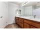 Bathroom with double sinks, a large mirror, and modern fixtures at 17413 W Mandalay Ln, Surprise, AZ 85388