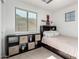 Cozy bedroom with a twin bed, neutral decor, and natural light from the large window at 17413 W Mandalay Ln, Surprise, AZ 85388