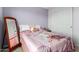 Bright bedroom featuring a double bed, with a themed comforter, mirror, and closet at 17413 W Mandalay Ln, Surprise, AZ 85388