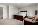 Bright bedroom featuring a large bed, comfortable sofa, and neutral color palette at 17413 W Mandalay Ln, Surprise, AZ 85388