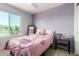 Bedroom with a princess theme, featuring a double bed, bright colors, and a large window at 17413 W Mandalay Ln, Surprise, AZ 85388