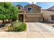 Charming two-story home with a well-manicured lawn and a two car garage in a residential neighborhood at 17413 W Mandalay Ln, Surprise, AZ 85388