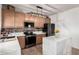 Kitchen featuring stone countertops, decorative tile backsplash, and stainless steel appliances at 17413 W Mandalay Ln, Surprise, AZ 85388