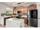 Kitchen featuring stone countertops, decorative tile backsplash, and stainless steel appliances at 17413 W Mandalay Ln, Surprise, AZ 85388