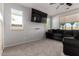 Comfortable living room with a modern television, plush seating, and bright windows, perfect for relaxation and entertainment at 17413 W Mandalay Ln, Surprise, AZ 85388