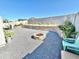 Landscaped backyard with rock, fire pit, and seating at 18230 W Poston Dr, Surprise, AZ 85387