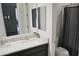 Bathroom featuring double sinks, granite counters, and shower at 18230 W Poston Dr, Surprise, AZ 85387