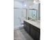 Bathroom featuring double sinks, granite counters, and glass shower at 18230 W Poston Dr, Surprise, AZ 85387