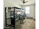 Bedroom setup with elevated bed and desk at 18230 W Poston Dr, Surprise, AZ 85387