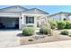Charming home exterior with open garage and front garden at 18230 W Poston Dr, Surprise, AZ 85387