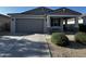 Charming single-story home with well-maintained landscaping, a spacious driveway, and a welcoming covered porch at 18230 W Poston Dr, Surprise, AZ 85387