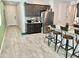 Spacious kitchen with breakfast bar, stainless steel appliances, and tile floors at 18230 W Poston Dr, Surprise, AZ 85387