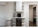 A bar and beverage area with a wine cooler, coffee machine, and floating shelves for storage and décor at 1894 E Julie Dr, Tempe, AZ 85283