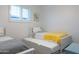 Bright bedroom featuring twin beds with trundles, plantation shutters, and neutral decor at 1894 E Julie Dr, Tempe, AZ 85283