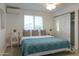 Bright bedroom with a queen size bed, overhead lighting, and bright windows at 1894 E Julie Dr, Tempe, AZ 85283