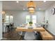 Spacious dining room with a large wooden table, modern seating, and a view into the backyard at 1894 E Julie Dr, Tempe, AZ 85283