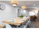 Bright dining room with a large wooden table, modern lighting, and a view into the living room at 1894 E Julie Dr, Tempe, AZ 85283