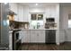 Well-lit kitchen featuring white cabinets, quartz counters, stainless appliances, and decorative mosaic backsplash at 1894 E Julie Dr, Tempe, AZ 85283